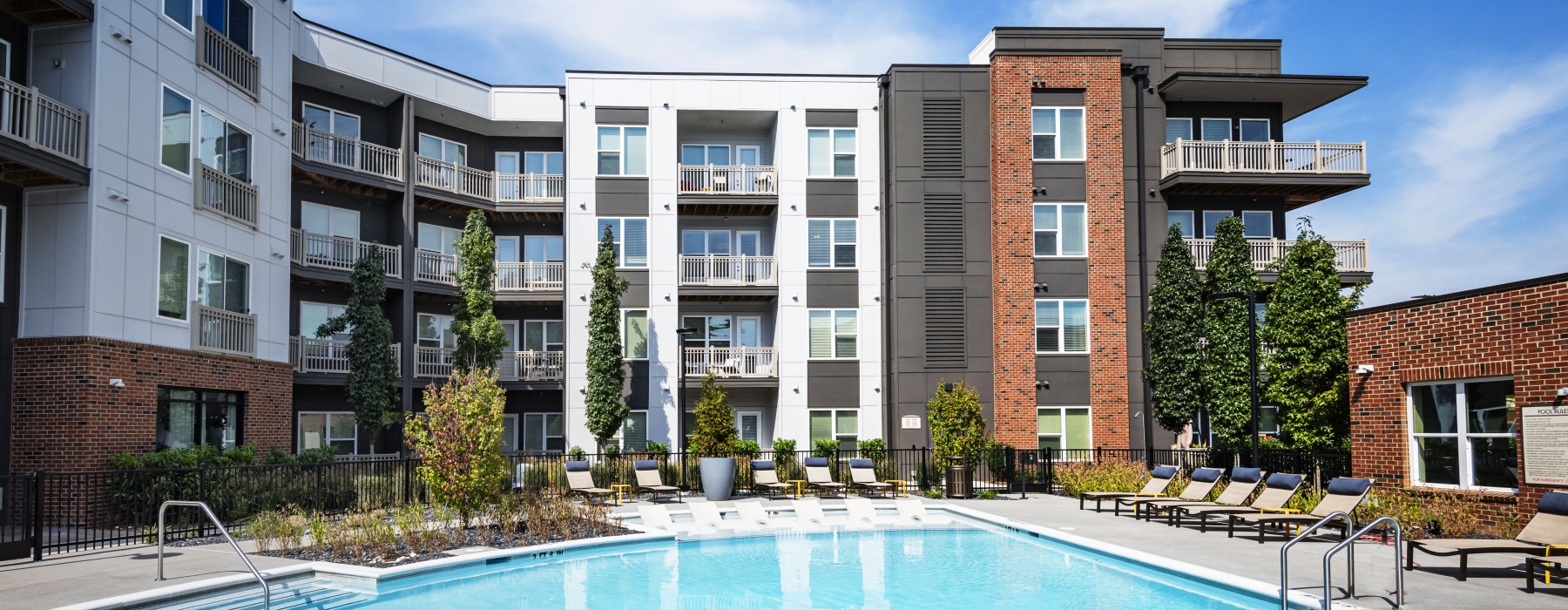 Spacious sparkling pool with sundecks and cabanas for lounging.